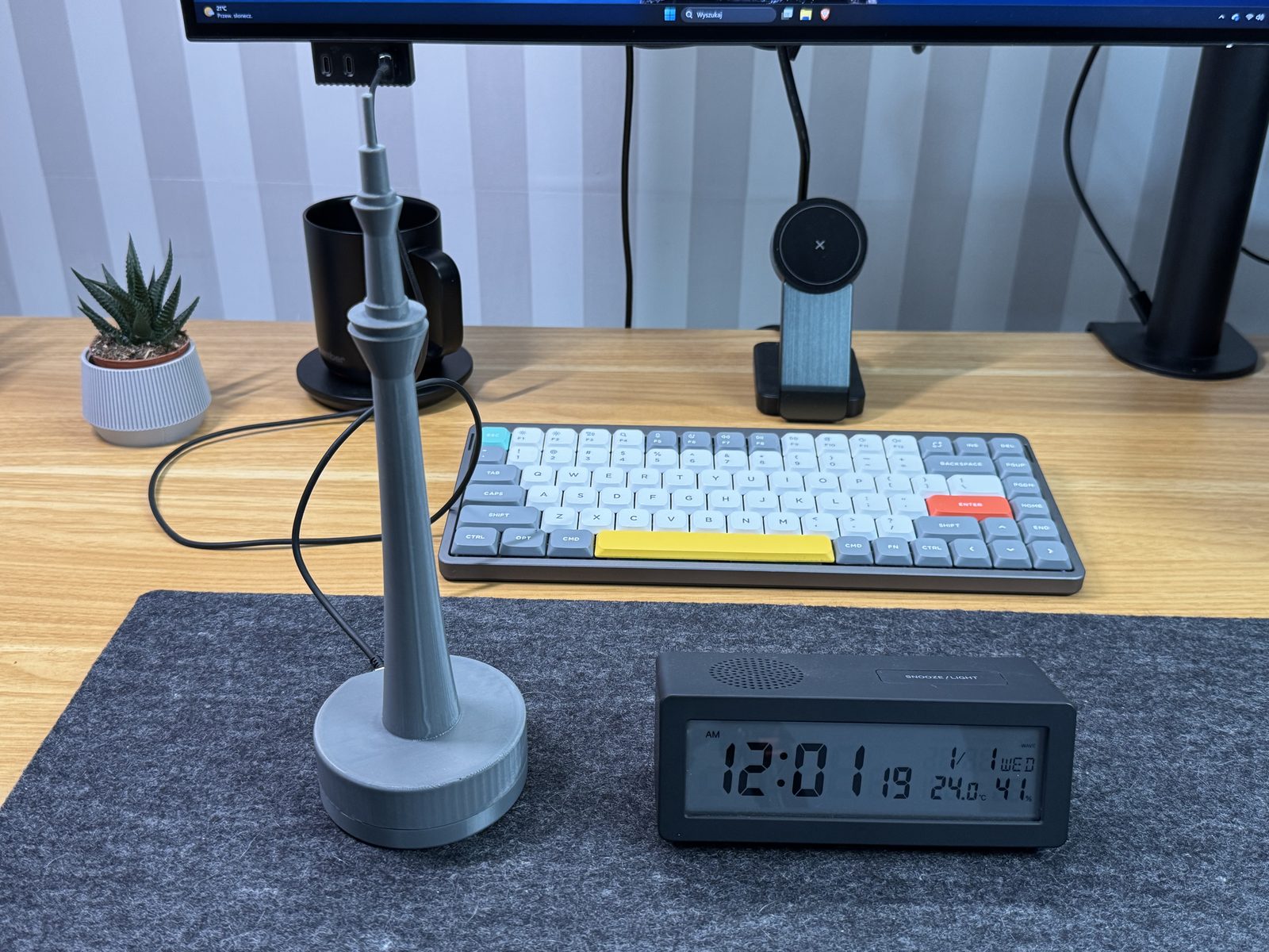 Assembled Tokyo Skytree enclosure next to the Muji clock it syncs